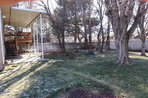 View of yard with a patio and a wooden deck