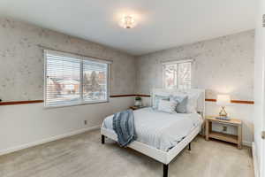 Bedroom featuring light carpet