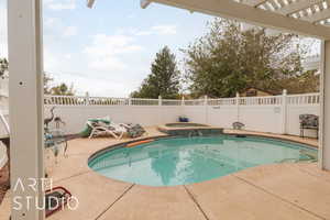 View of pool featuring an in ground hot tub, a patio area, and a pergola