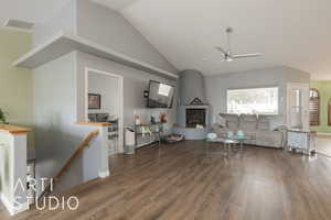 Living room featuring ceiling fan, lofted ceiling, and dark hardwood / wood-style flooring