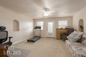 Workout area with light carpet, a textured ceiling, and ceiling fan