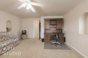 Carpeted office space featuring ceiling fan and a textured ceiling