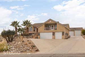 View of property with a balcony and a garage