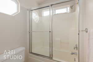 Bathroom with combined bath / shower with glass door