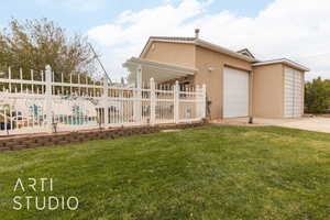 Exterior space with a pergola, a garage, and a front lawn