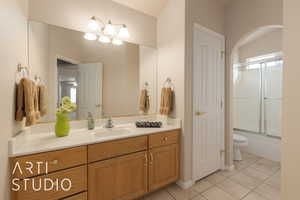 Full bathroom featuring vanity, toilet, bath / shower combo with glass door, and tile patterned flooring