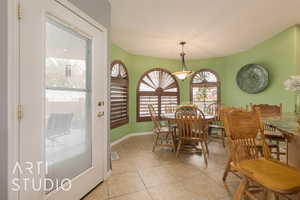 Dining area featuring light tile patterned flooring