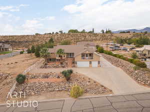 View of front of property with a garage and a mountain view