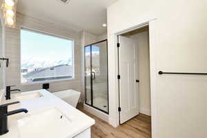 Bathroom featuring hardwood / wood-style floors, plenty of natural light, and separate shower and tub