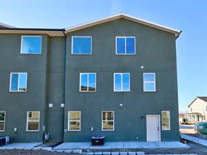 Rear view of house featuring central AC unit