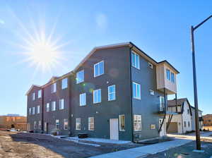 View of property with a garage and central AC