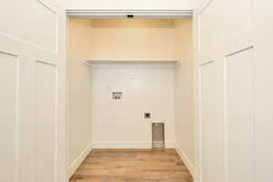 Laundry area featuring washer hookup, light hardwood / wood-style flooring, and electric dryer hookup