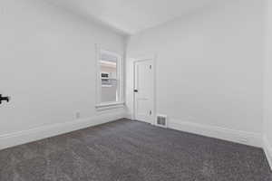 Spare room with dark carpet