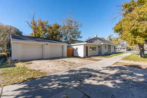 Single story home with a garage and an outdoor structure