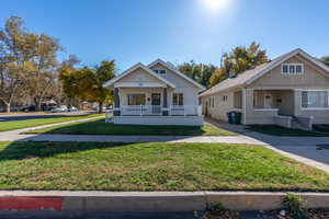 Bungalow featuring a porch and a front lawn