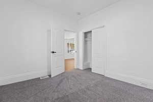 Unfurnished bedroom with carpet floors and a closet