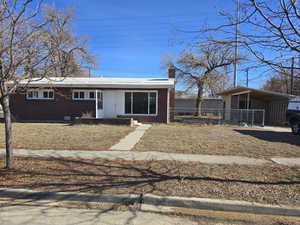 View of front of property featuring a carport