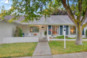 View of front of property with a front yard and a porch