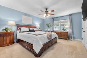 Carpeted bedroom with ceiling fan