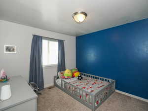 Bedroom featuring a textured ceiling and carpet