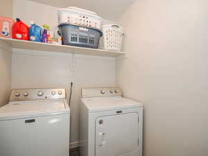 Washroom with washer and clothes dryer