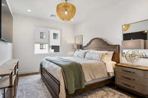 Bedroom with hardwood / wood-style flooring