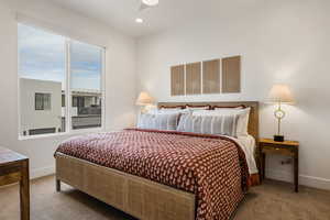 Carpeted bedroom with ceiling fan