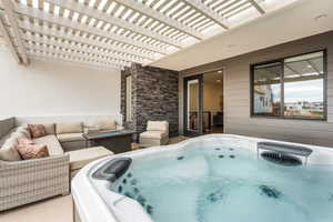 View of patio featuring a pergola and a hot tub