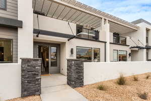 Entrance to property featuring a pergola