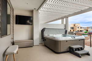 View of patio / terrace featuring a hot tub and a pergola