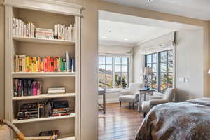 Bedroom with crown molding and wood-type flooring