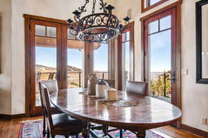 Dining space with wood-type flooring and french doors