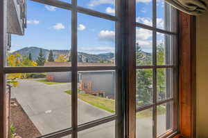 Doorway to outside with a mountain view and a healthy amount of sunlight