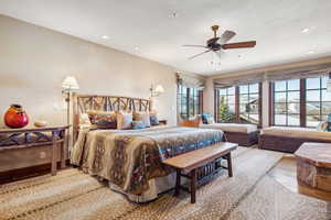 Bedroom with ceiling fan and wood-type flooring