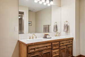 Bathroom with vanity and decorative backsplash