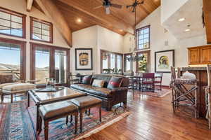 Living room featuring hardwood / wood-style floors, wood ceiling, french doors, and a high ceiling