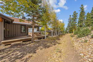 View of yard with a hot tub and a wooden deck