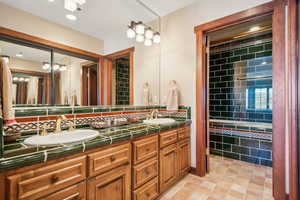 Bathroom with vanity and decorative backsplash