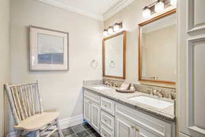 Bathroom featuring ornamental molding, tile patterned floors, and vanity