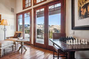 Entryway with a high ceiling, a mountain view, and hardwood / wood-style floors