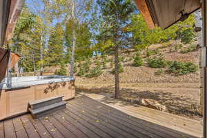 Wooden deck featuring a hot tub