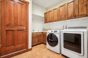 Clothes washing area with cabinets and washing machine and clothes dryer