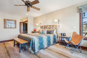 Bedroom with wood-type flooring, ceiling fan, and a closet