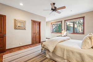 Bedroom with hardwood / wood-style flooring and ceiling fan