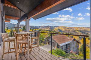 Wooden terrace featuring a mountain view