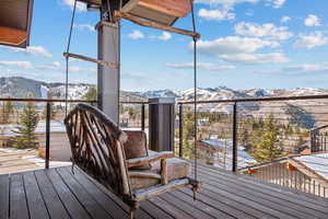 Snow covered deck with a mountain view