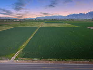 Aerial view at dusk featuring a mountain view and a rural view