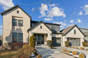 View of front of home featuring a garage and french doors