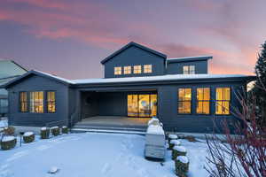 Snow covered property with covered porch