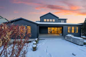 Snow covered property with an outdoor kitchen